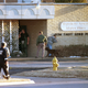 A bomb squad inspects a clinic in Tulsa after the clinic was struck twice, 1997, AP